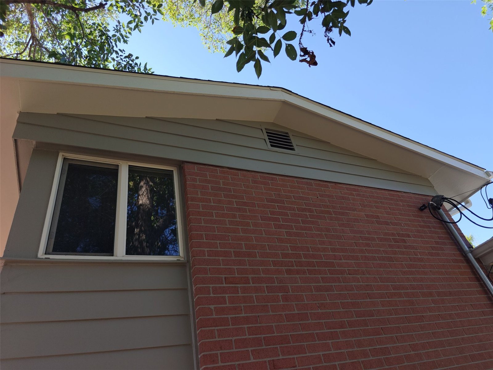 After: repainted brick and siding corner of the Arvada home